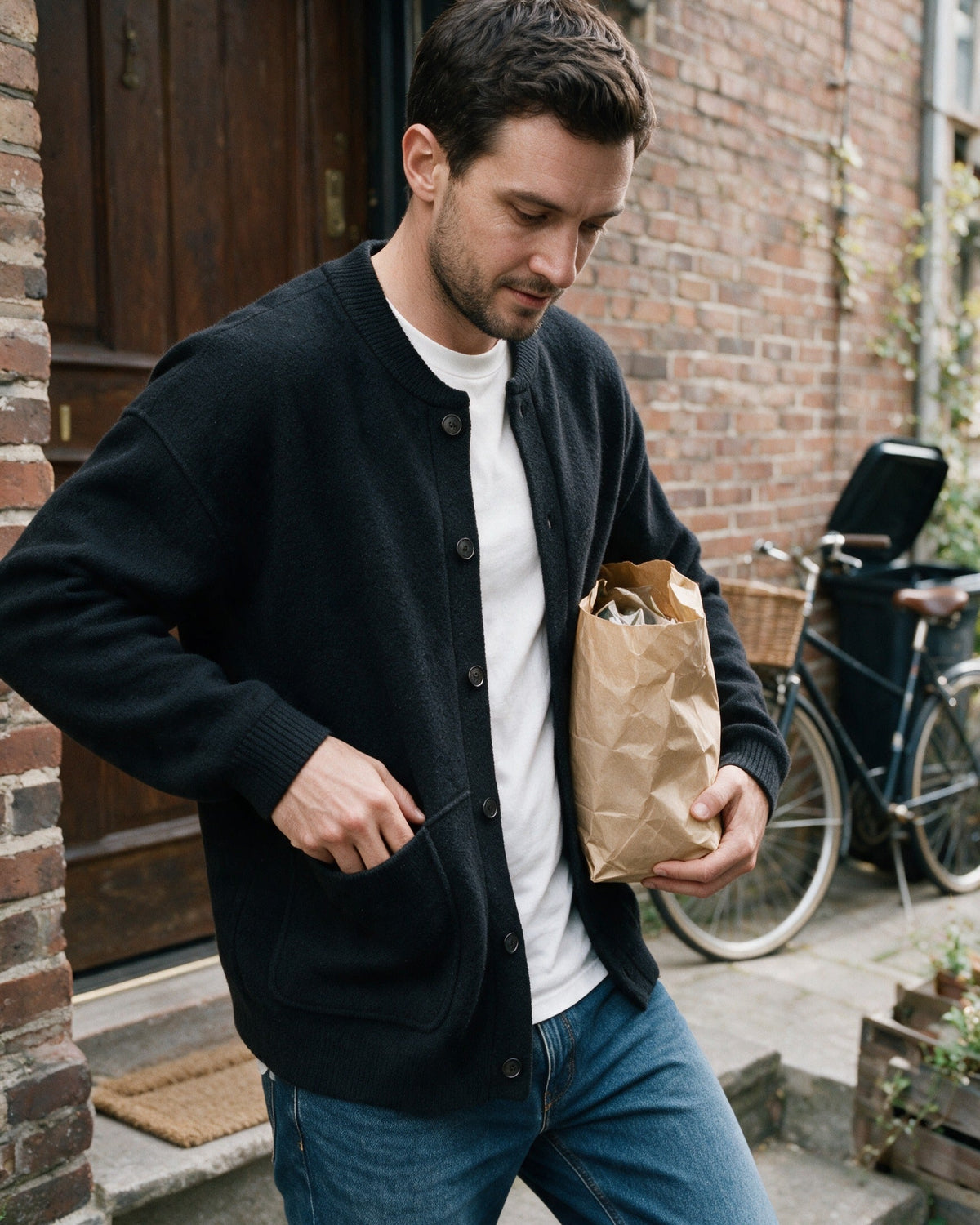 Man in the Beaufort cardigan arriving home with groceries