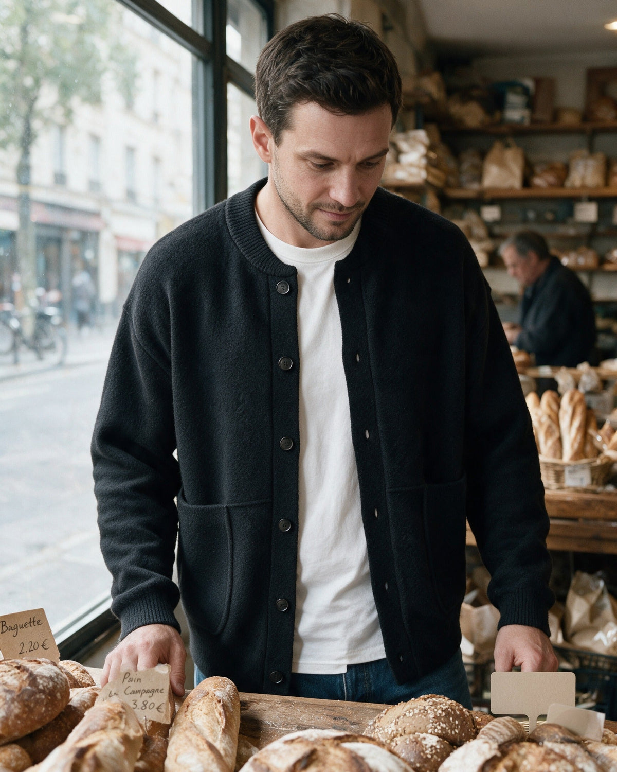 Man wearing the Beaufort cardigan at a bakery