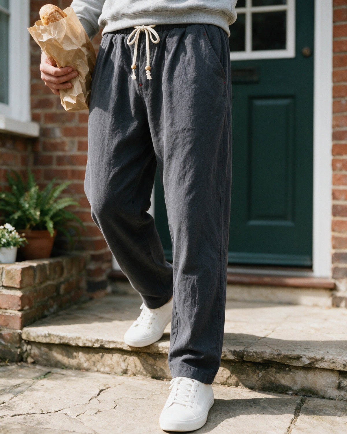 Whitby drawstring trousers in Charcoal, stepping out of the house